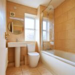 Family bathroom with beige tiles property to rent in Milton Keynes