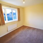 Unfurnished bedroom with beige curtains in Milton Keynes rental property