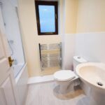 Bathroom with shower bath and white floors