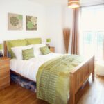 Bedroom with green accessories and pillows