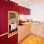 Kitchen with red cupboards in Milton Keynes rental property