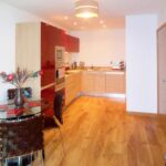 Kitchen and dining room with red cupboards