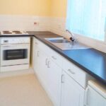 Black and white kitchen with yellow walls