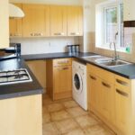 Kitchen and dining room with white goods in house to rent in Milton Keynes