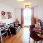 Open plan living and dining area with red accessories