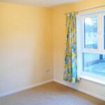 Bedroom with yellow and blue patterned curtains