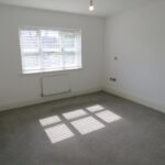 Large bedroom with grey carpet in Milton Keynes rental home