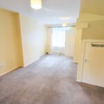 Living room with cupboard under the stairs