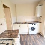 Kitchen with white goods and gas hobs