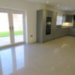 Large kitchen diner with double doors leading to the back garden in Milton Keynes rental property