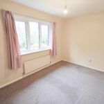 Bedroom with pink curtains in Milton Keynes rental property