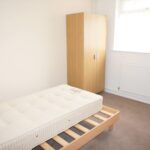 Furnished bedroom with wooden closet in house to rent Milton Keynes