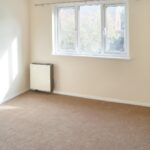 Sunny unfurnished room with brown carpet in 1 bedroom house to rent Milton Keynes