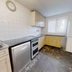 Kitchen with fridge, dishwasher and cream cabinets