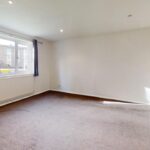 Unfurnished living room with curtains in rental apartment