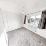 Bedroom with grey curtains and carpet