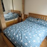 Furnished bedroom with wardrobe and double bed