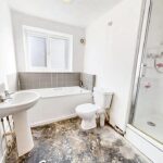 Bathroom with bath, shower and flamingo decor in flat to rent near Milton Keynes