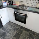 Kitchen decorated in black and white with gas hob