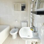 Bathroom with multiple mirrors and a bidet in MK rental property