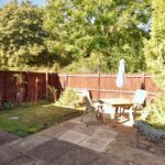 Back garden with wooden furniture in three bedroom house to rent in Milton Keynes