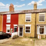 Exterior view of mid terrace house with off road parking near Milton Keynes