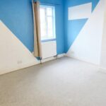 Unfurnished room with blue and white painted walls in rental property near Milton Keynes