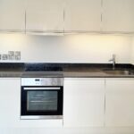 Kitchen with sparkly black countertops in flat to rent near Milton Keynes