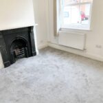 Unfurnished room with period fireplace and front door in rental property near Milton Keynes