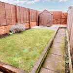 Private back garden with high fences for privacy and a wooden shed in house to rent near Milton Keynes