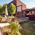 Back garden with wooden furniture in Milton Keynes rental property