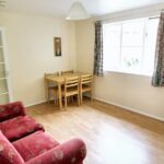 Furnished living and dining room with plenty of light from large windows in flat to rent near Milton Keynes