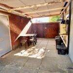 Covered carport with furniture in rental property