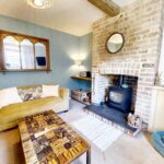 Living room with feature brick fireplace in Milton Keynes rental property