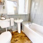 Bathroom with modern grey tiles in property for rent in Milton Keynes