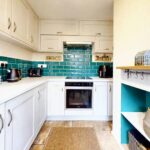 Charming kitchen decorated in white and teal in 3 bedroom house to rent in Milton Keynes